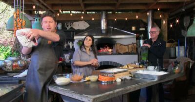 James Martin rubs his arm after singeing it