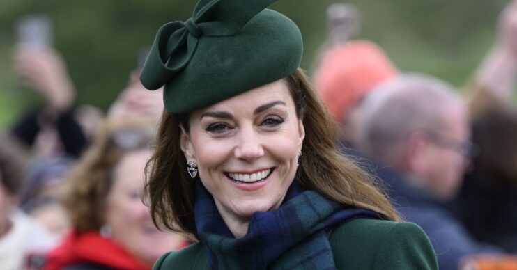 Princess Kate smiling in green outfit during Christmas Day walkabout