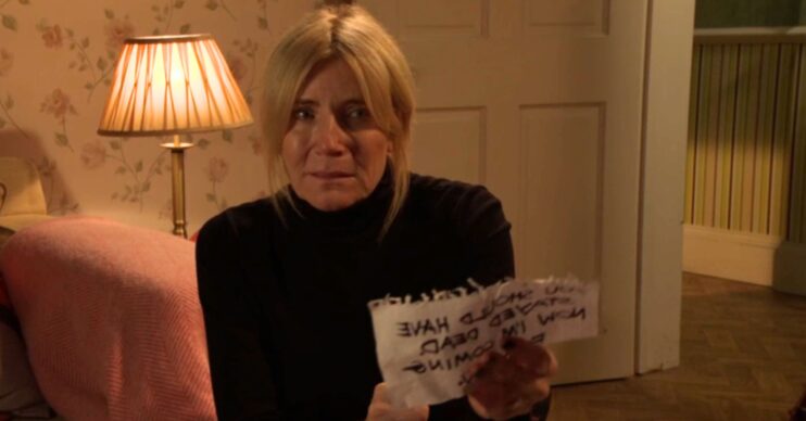 Cindy looks upset as she holds a note on EastEnders (Credit: BBC/Composite: ED!)