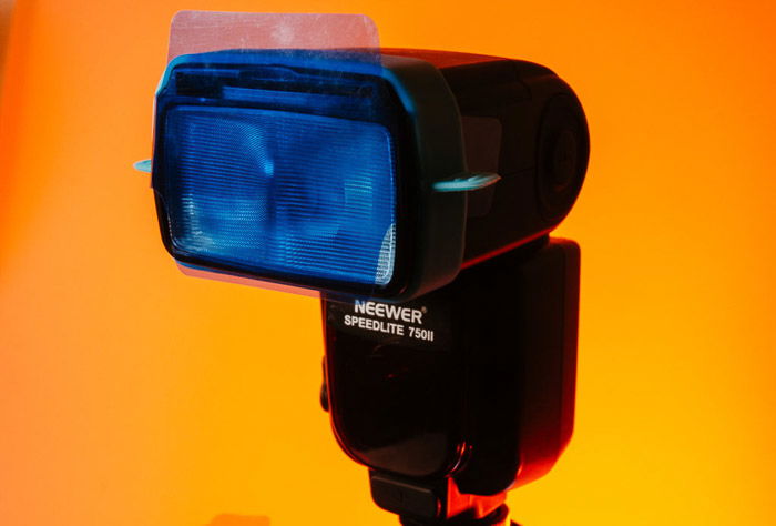 Close up of a speedlight on bright orange background