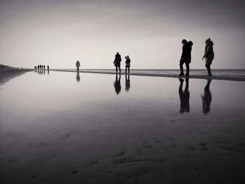 Group of people walking on beach