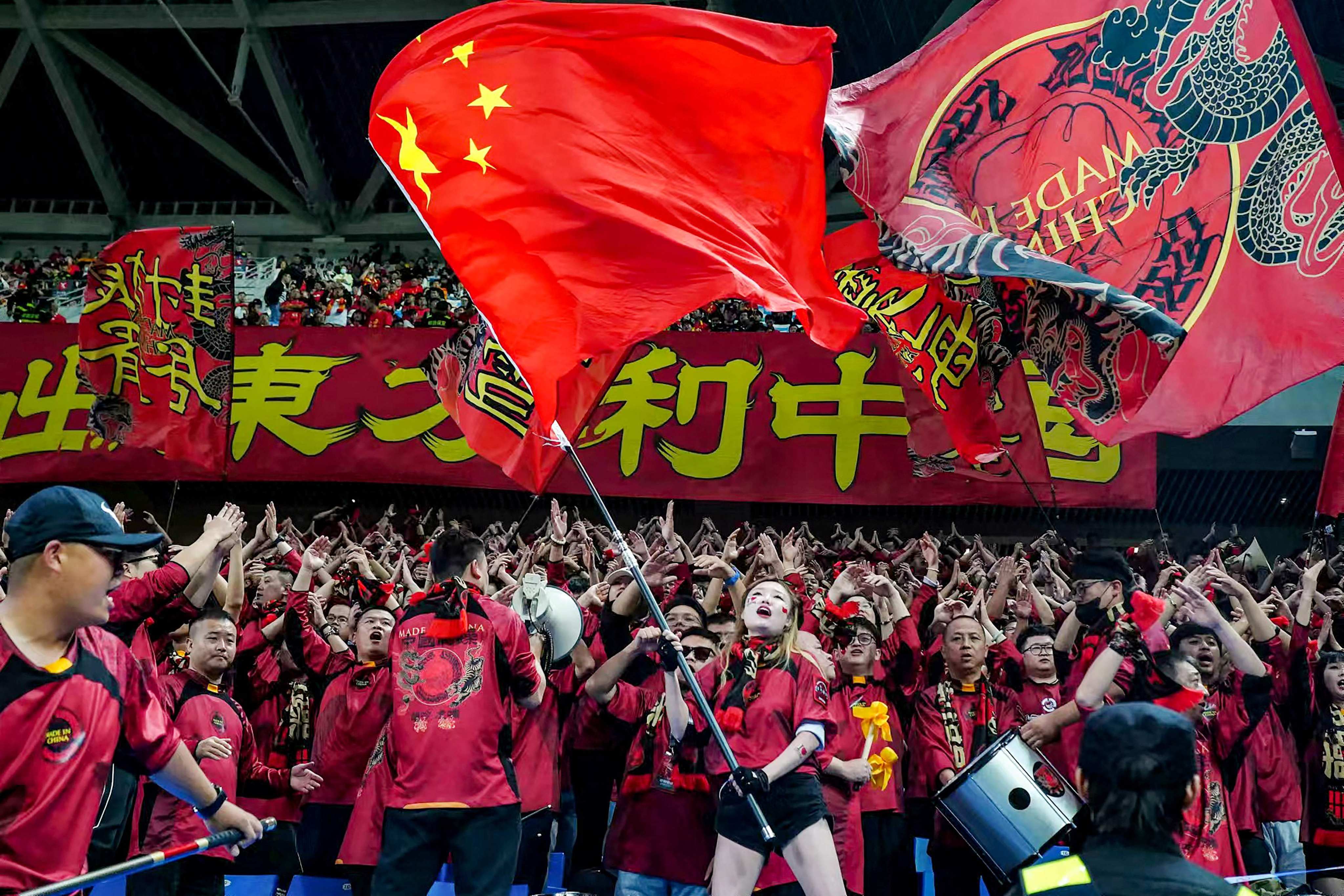 Chinese football fans 
celebrate their team’s win against Indonesia at the 2026 Fifa World Cup Asian qualification match in Qingdao, China, on October 15. Photo: AFP