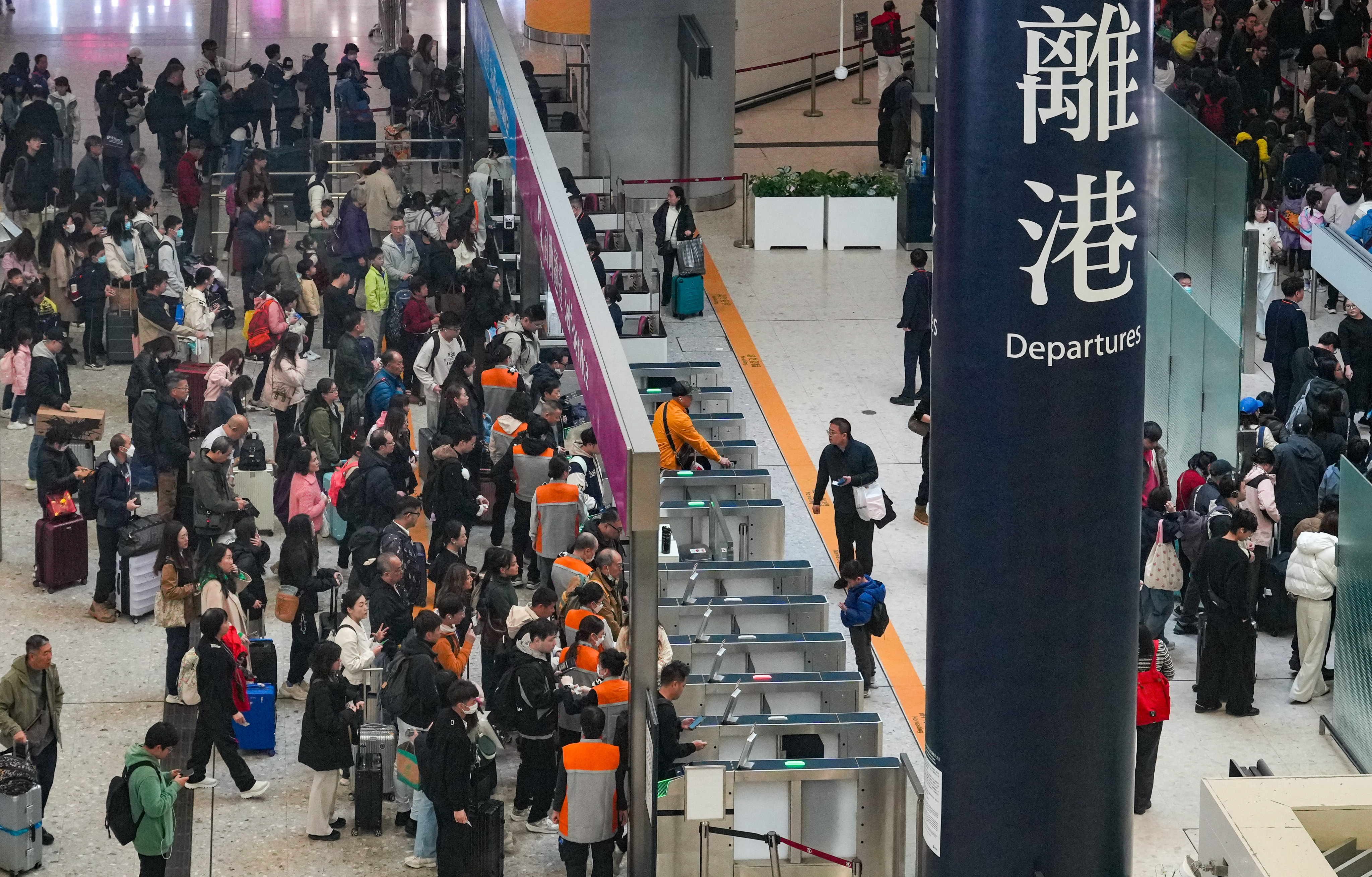 Travelers at the departure hall of West Kowloon railway station on December 22. Photo: May Tse