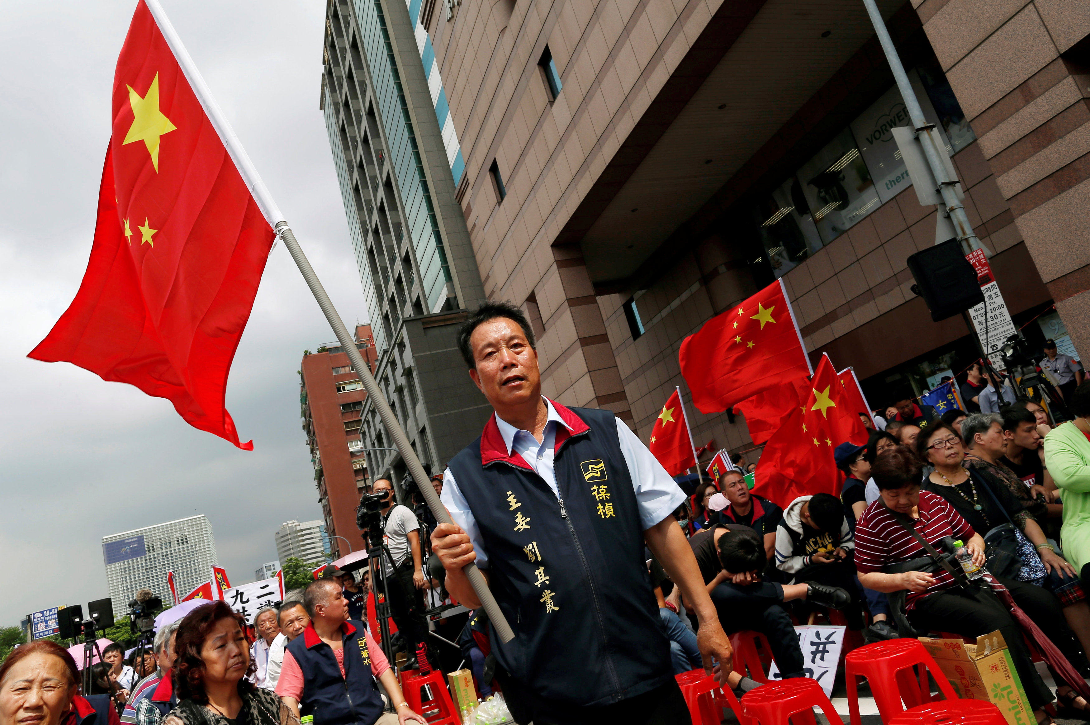 A member of Taiwan’s China Unification Promotion Party carries a flag at a rally in Taipei in 2016. Photo: Reuters