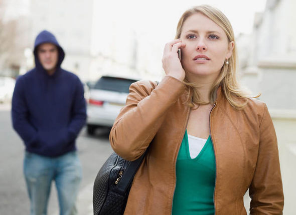 Woman talking on her phone and being followed