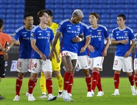 Yokohama F Marinos striker Anderson Lopes, center, hangs his head after he and his teammates lost to Nagoya Grampus in their Levain Cup semifinal first-leg match at Yokohama's Nissan Stadium on Oct. 9, 2024. (Kyodo)