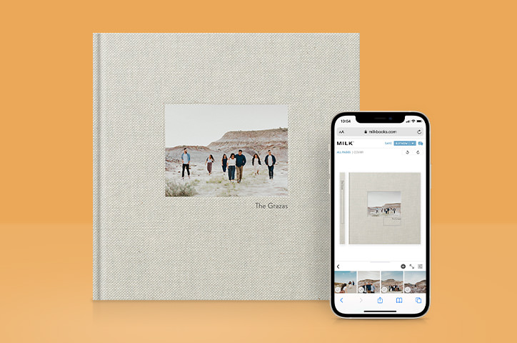MILK Premium Photo Book and smartphone next to it displaying the Online Design Studio