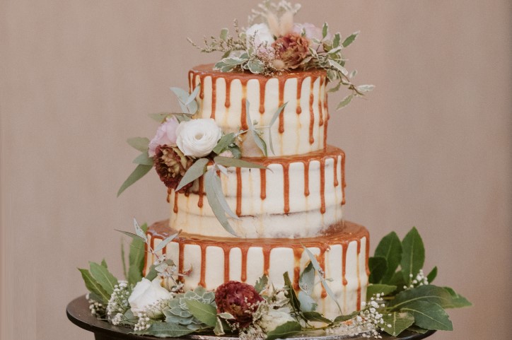 Three tiered wedding cake with caramel drizzle