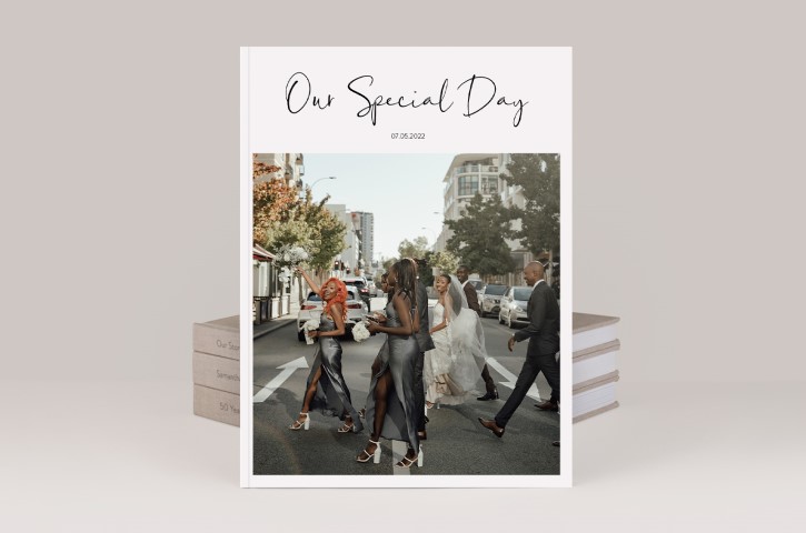 Three premium photo books with wedding magazine standing in front titled "Our Special Day"