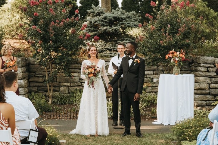 Wedding couple in front of flowers