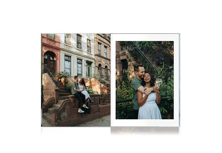 Portrait Photo Book of engaged couple embracing on brick steps by potted plants