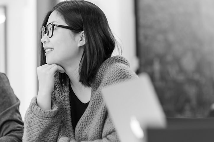 Black and white photo of MILK Books head of design sharing her ideas.