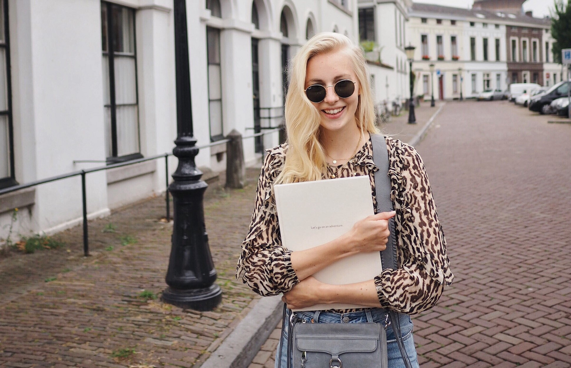 Anne Stikvoort holding photo book.