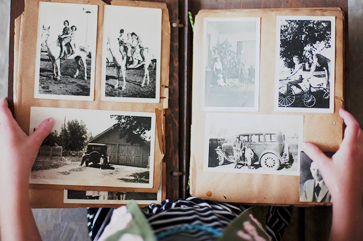 Birds eye view of a traditional photo album with black and white photos.