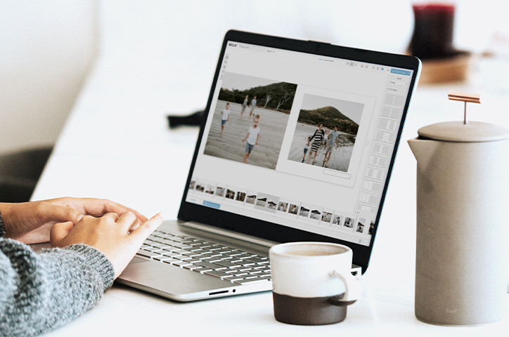 Person at mac laptop on Design Studio with cup of coffee