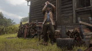 Arthur Morgan chops wood.