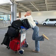 Caro Daur at the airport with suitcases