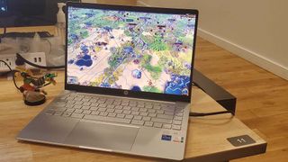 An HP Pavilion Plus 14 on a desk playing Civ VI