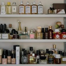 Photo of many perfumes on a vanity shelf 