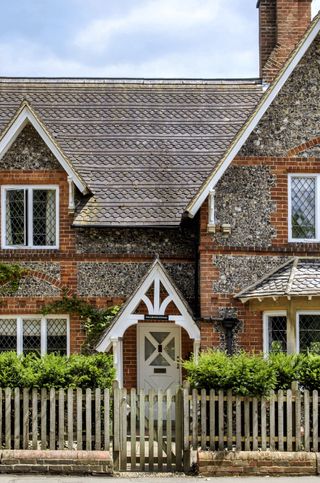 exterior of cottage with white front door with porch