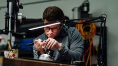 Logan Olson working on a putter in his workshop