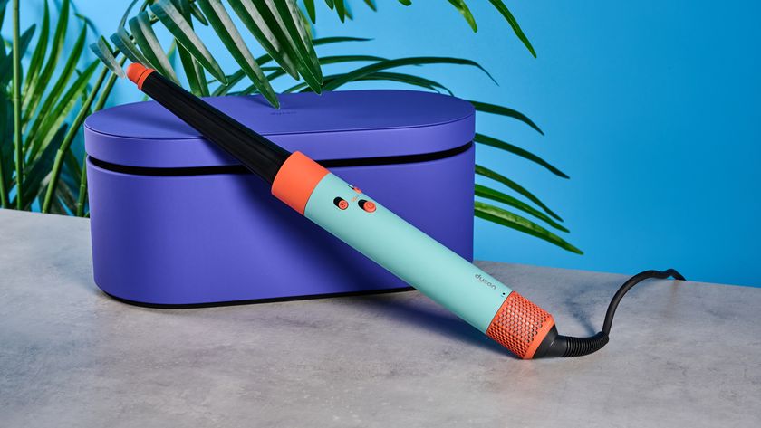 the dyson airwrap ID in teal and terracotta colorway (patina and orange) with a lapis case, with a brush, hairfryer, curling wand attachments