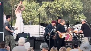 Neil Young, Stephen Stills and John Mayer playing guitar on stage