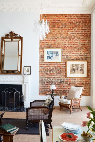 a brick fireplace alcove with ornate cornicing