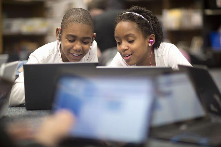 Two students using technology to learn