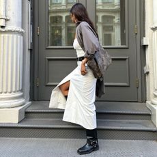 Biker boots with circular buckle detail on ankle and white dress.