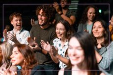 group of people laughing in a theatre