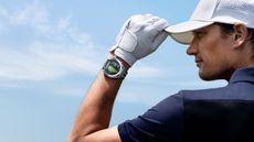 A golfer wearing a HUAWEI watch