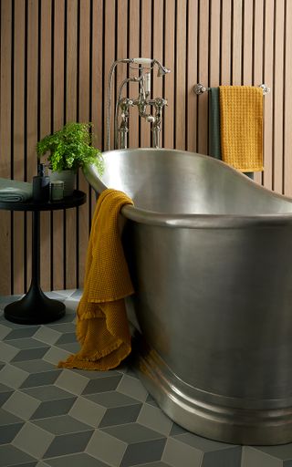 tin bath in bathroom with wood panel wall