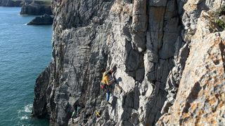 how to start sea cliff climbing: climber on a route