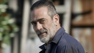 Negan smirking at Maggie in The Walking Dead.