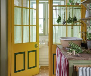 rustic utility room with yellow glass door leading to downstairs toilet