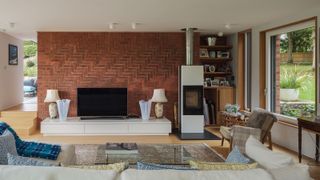 a herringbone brick wall with a stove in front