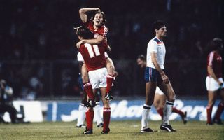 Goalscorer Allan Simonsen celebrates with Klaus Berggreen (11) as England defender John Gregory looks on after Denmark had beaten England 1-0 in their European Championship Qualifying match at Wembley Stadium on September 21, 1983 in London, England.