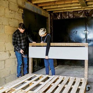 garage with wooden pallets and hammer