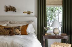 white bedroom withh green curtains by Marie Flanigan