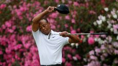 tiger woods looking disappointed on the 13th green at August National