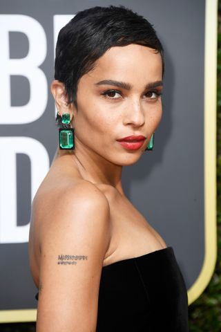 Zoe Kravitz wearing her hair short in a pixie cut.