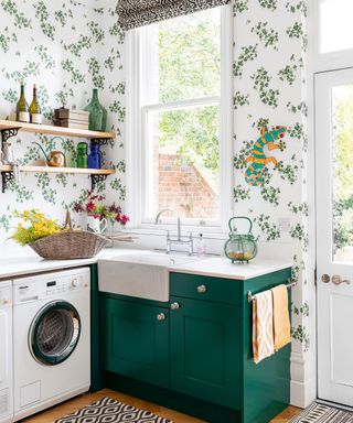 bright light kitchen with green cabinets and green floral wallpaper