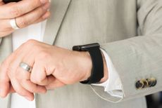 Caucasian man in a suit wearing an Apple Watch