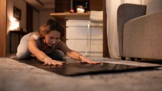 A woman practising yoga in the evenings for better sleep