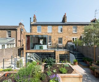 rear house extension with ground and lower level additions in glass and brick