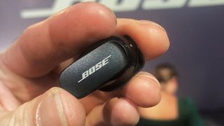 Bose QuietComfort Earbuds II held in hand