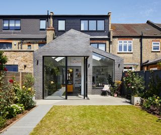 kitchen extension at rear of property wth grey cladding and large glazed openings