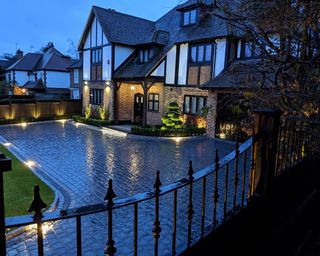 drive with railing and lighting and big house