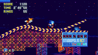 Sonic and Tails race across an orange track, against a dark, starry night backdrop